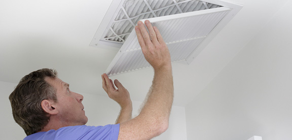 Air Conditioning Duct Sealing This image shows a man cleaning an airduct.