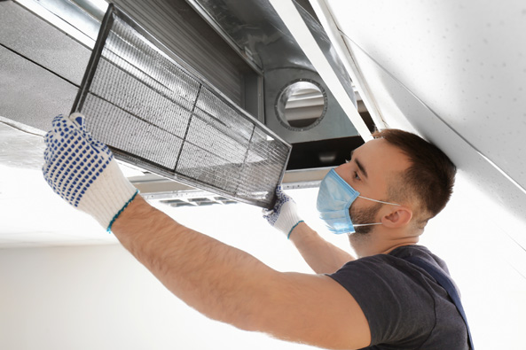 Air Duct Cleaning And Repair This image shows a man cleaning an airduct.
