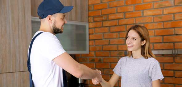 This image shows a man and a woman shaking hands.